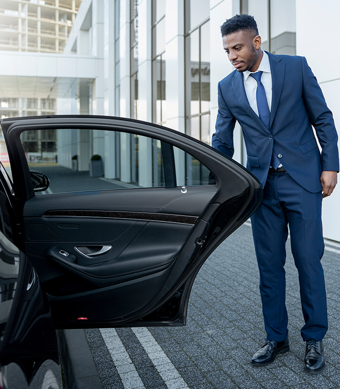 Luxury Chauffeur Greeting Passenger